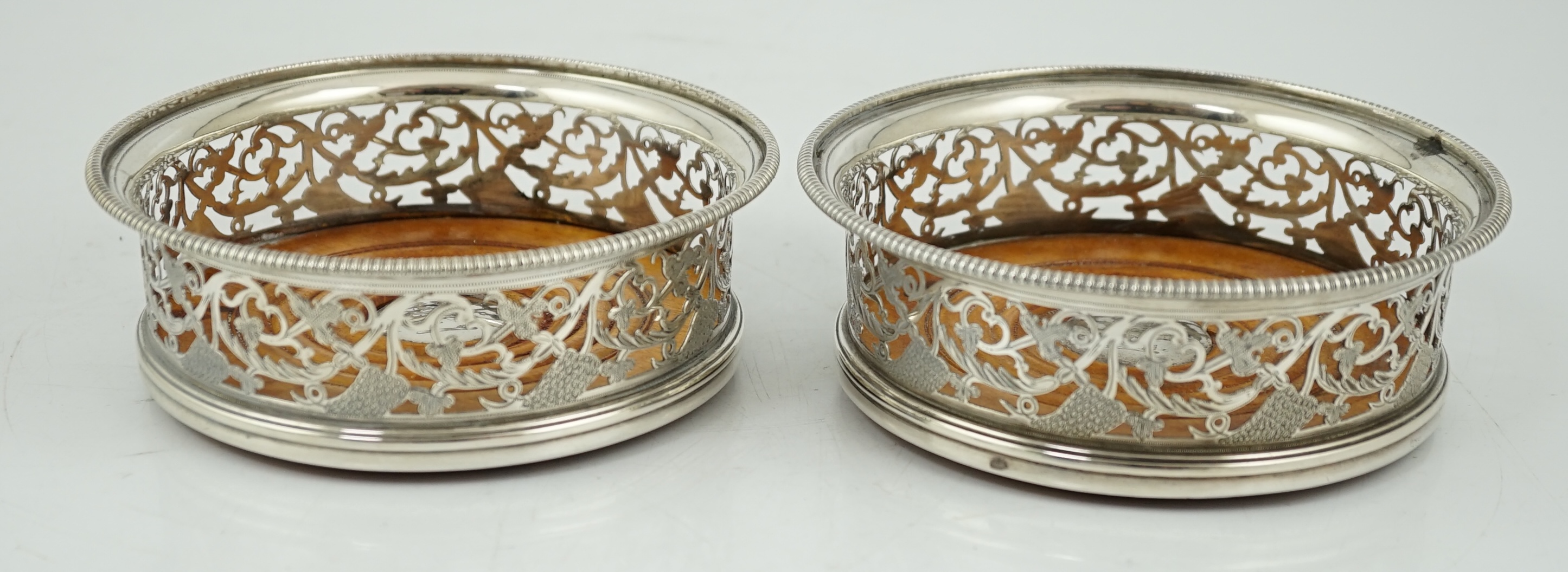 A pair of George III pierced silver mounted wine coasters, William Allen III